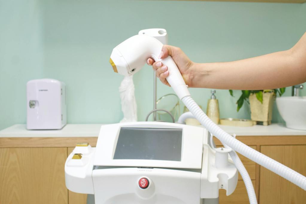 a person holding a white cosmetic machine